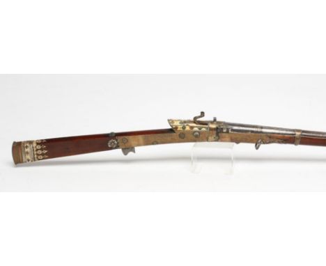 AN INDIAN MATCHLOCK TORADAR MUSKET, the 45" barrel flared at the bore with remnants of gilt design and integral pan with deco