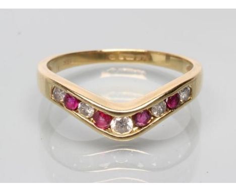 A NINE STONE RUBY AND DIAMOND HALF HOOP ETERNITY WISHBONE RING, the four rubies and five diamonds channel set to a plain 18ct