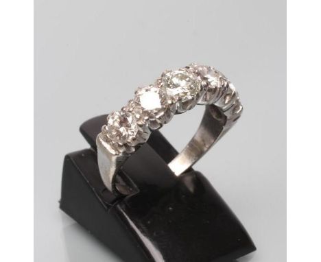 A SIX STONE DIAMOND HALF HOOP ETERNITY RING, the brilliant cut stones claw set to a plain unmarked white shank, size L 1/2 (E