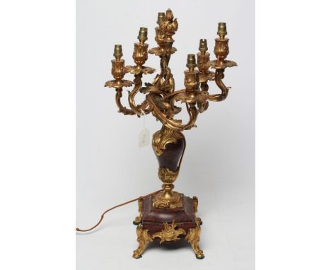 A LOUIS XV STYLE SIX LIGHT CANDELABRUM, in gilt metal and rouge griotte marble, the vase shaped marble stem issuing six scrol