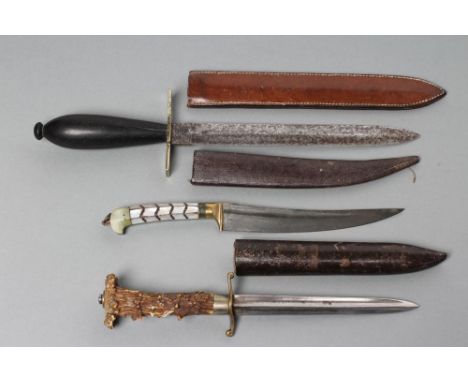 THREE SHEATHED DAGGERS, comprising a possible 19th century naval fighting knife, with double edged 7 3/4" blade, brass cross 