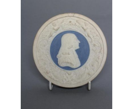 A VICTORIAN DRY BODIED ROUNDEL centrally applied with a bust portrait of Wesley on a blue ground below a coronet held aloft b