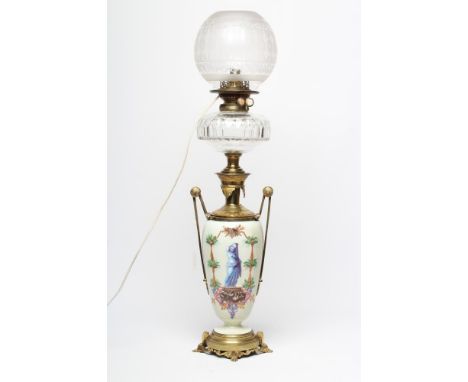 A VICTORIAN OIL LAMP, the slender ovoid glass body painted in polychrome enamels with a scantily draped classical female figu