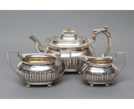 A LATE VICTORIAN SILVER THREE PIECE TEA SERVICE, maker Walker & Hall, Sheffield 1897, of semi-fluted rounded oblong baluster 