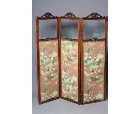 A VICTORIAN WALNUT FOLDING ROOM SCREEN, each part glazed panel with arched leaf and scroll carved crest centred by a shell an