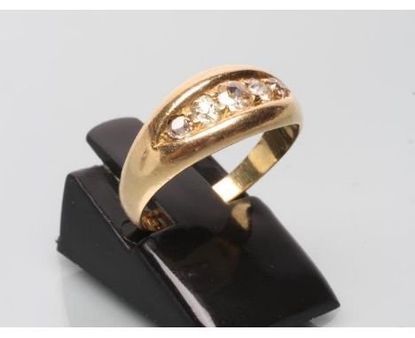 A VICTORIAN FIVE STONE DIAMOND RING, the graduated old cut stones claw set to an eliptical panel to a plain 18ct gold shank, 