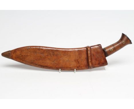 A MILITARY KUKRI, the 13 3/4" curved and fullered blade stamped "PIONEER CALCUTTA 43", two piece wood grip and leather covere