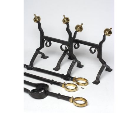 A SET OF ARTS AND CRAFTS STYLE WROUGHT IRON FIRE IMPLEMENTS, the square section shafts with spiral fluted collars and brass r