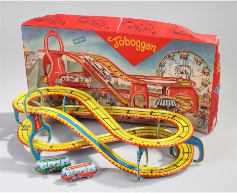 West Germany tinplate toy, with a track in yellow with two clock work buses