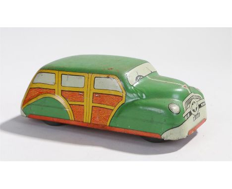 Mettoy clockwork tin plate toy car, Woody Wagon, the green roof above yellow and wood effect doors, number plate MT 3312, Mad