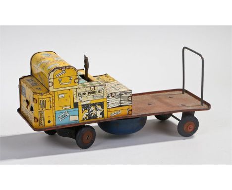 British made tin plate clock work toy baggage trailer, with yellow front with yellow decorated trunks and parcels, key wound 