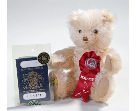 Merrythought, gold plush teddy bear named 'Jeremy' by John Axe, with original label and passport