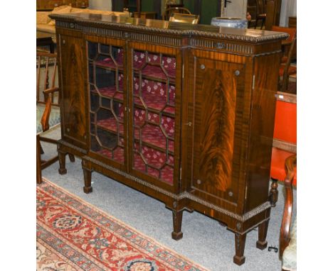 A 20th century Chippendale style mahogany break front bookcase, with gadrooned mouldings, astragal glazed, on square supports
