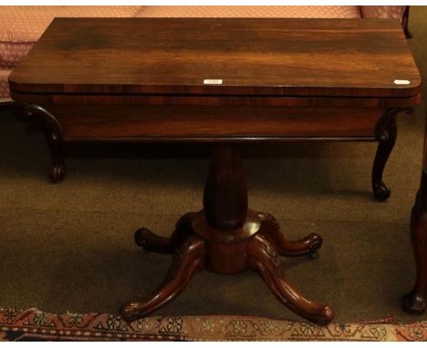 An early Victorian rosewood fold-over card table with octagonal baluster centre pedestal on four carved supports, 88cm by 43c