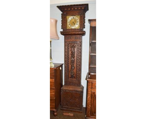 A carved oak thirty hour longcase clock, 11'' square brass dial, unsigned, 229cm high .  With pendulum and one weight 