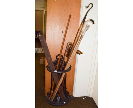 A Victorian cast iron stick stand and quantity of assorted sticks etc also including a brass kit measure by makers E.Preston 