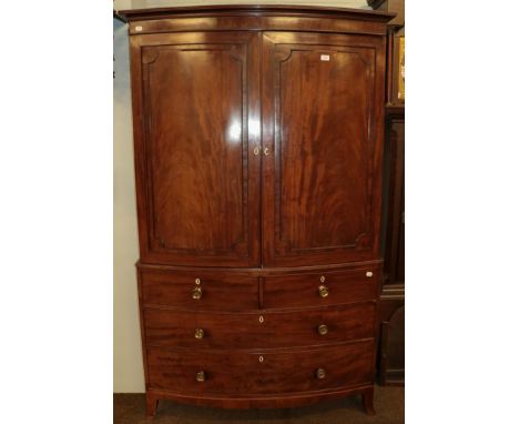 A Regency mahogany bow-front linen press, raised over a three-height chest base over splay bracket supports, 122cm by 58cm by