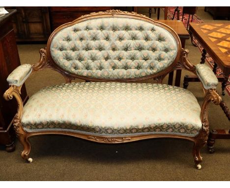 A Victorian carved walnut parlour sofa in the French taste with duck egg blue floral upholstery, raised on poc castors, 140cm