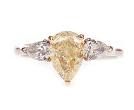 YELLOW AND WHITE DIAMOND RING, the central yellow pear shaped diamond of approximately 1.40 carats with accompanying IGI repo