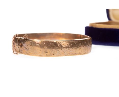 GOLD BANGLE, of oval form, with engraved decoration to the front section, in nine carat gold, 16.6g Please read the content o