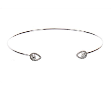 DIAMOND SET BANGLE, with pear shaped diamond set terminals, the round brilliant cut diamonds totalling approximately 0.60 car