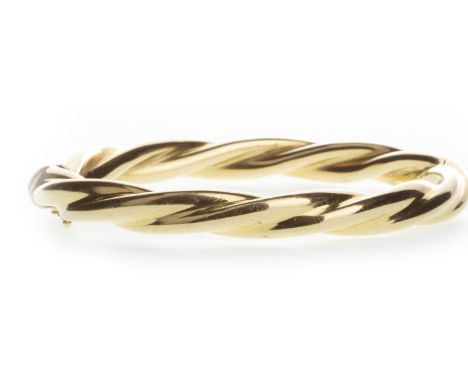 GOLD TWIST BANGLE, of oval form, 60mm inner diameter, in eighteen carat gold, 23.8g Please read the content of the ‘Important