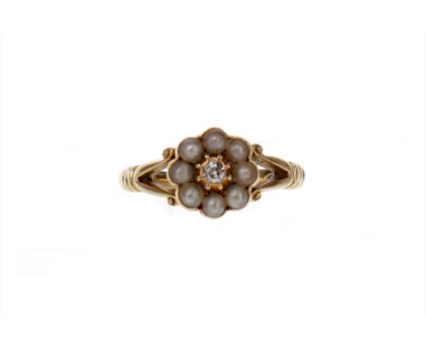 PEARL AND DIAMOND RING, the old cut diamond of approximately 0.05 carats within a seed pearl border, on bifurcated shoulders,