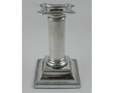 An Edwardian silver candlestick, with removable sconce, raised on square stepped base, hallmarked Birmingham 1907, by William