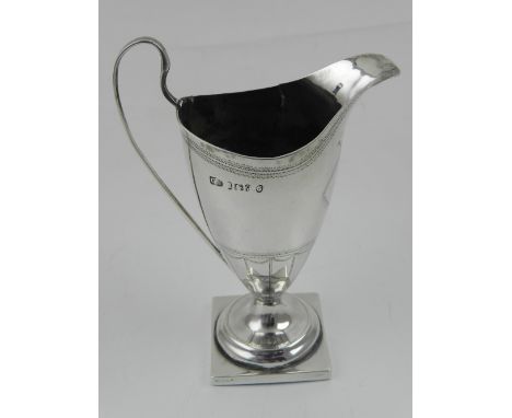 A George III silver helmet cream jug, raised on square base, hallmarked London 1782, by George Smith. H. 13cm