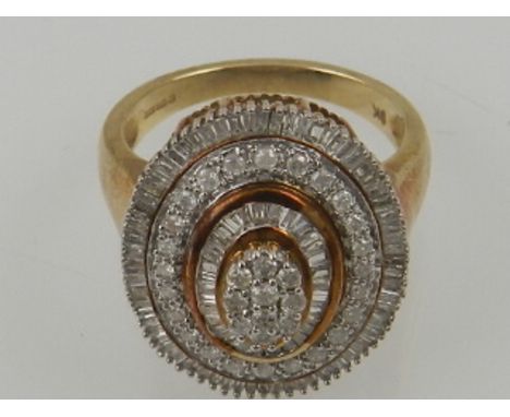 A 9 carat yellow gold and diamond set oval cluster ring.