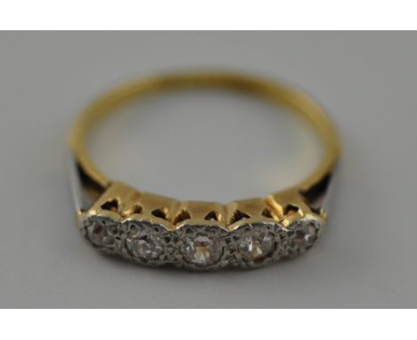 An 18 carat yellow gold, platinum, and diamond five stone ring, the graduated diamonds of approx. 0.40 carats combined.