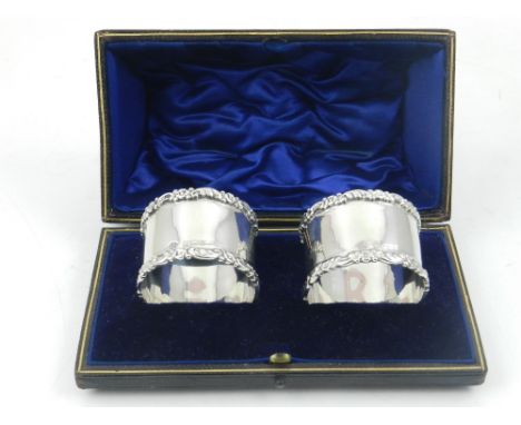 A cased pair of silver napkin rings, hallmarked William Hutton, Birmingham 1904