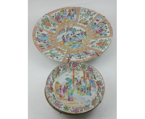 A large 19th century famille rose charger, D: 34cm , together with four side plates, decorated in courtyard scenes, D: 20cm.