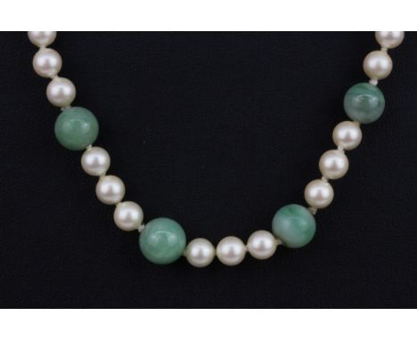 A polished jade bead and faux pearl necklace on a 9ct yellow gold clasp, L. 46cm.