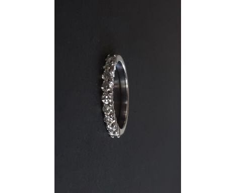 An 18ct white gold diamond set half eternity ring, approx. 0.60ct overall, (L.5).