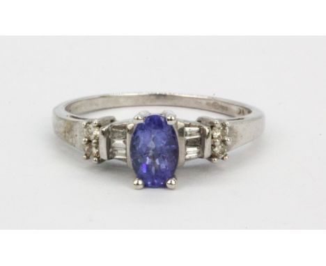 A 9ct white gold tanzanite and diamond set ring, (L).