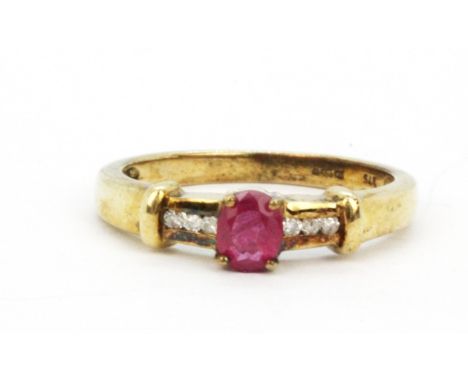 A 9ct yellow gold ring et with an oval cut ruby and diamond set shoulders, (M).