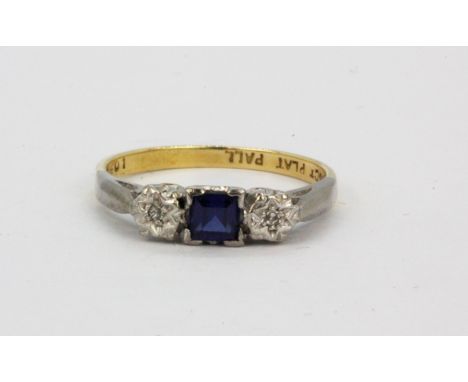 An 18ct yellow gold and platinum step cut sapphire and diamond set ring, (K.5).