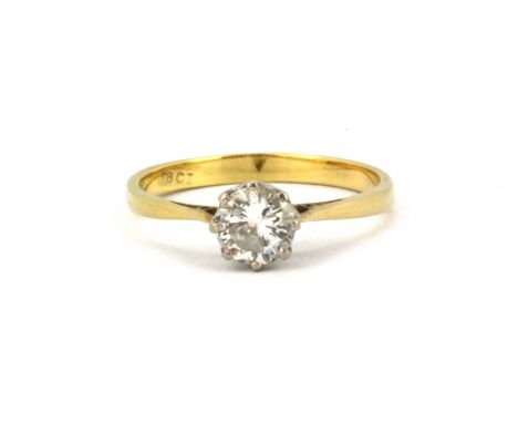 An 18ct yellow gold (stamped 18ct) solitaire ring set with a brilliant cut diamond, approx. 0.75ct, (O).