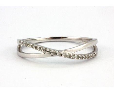 A 9ct white gold diamond set crossover ring, (O).