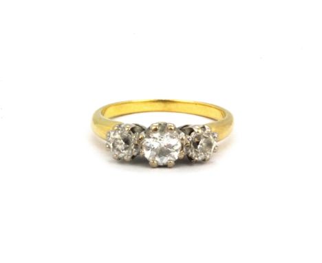 A yellow metal (tested 18ct gold) ring set with three old cut diamonds, (M).