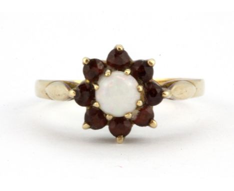 A 9ct yellow gold opal and garnet set cluster ring, (N.5).