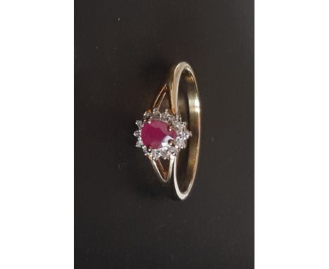 A 9ct yellow gold pear cut ruby and diamond set cluster ring, (P).