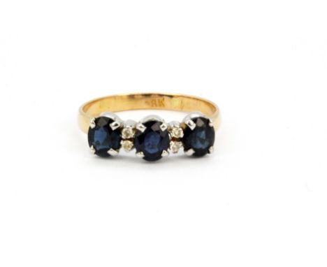 An 18ct yellow gold sapphire and diamond set ring, (K.5).