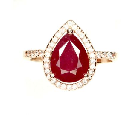 A 925 silver rose gold gilt adjustable ring set with a pear cut ruby and cubic zirconia.