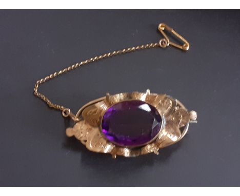 A Victorian gilt metal brooch set with a large oval cut amethyst, L. 4.5cm.