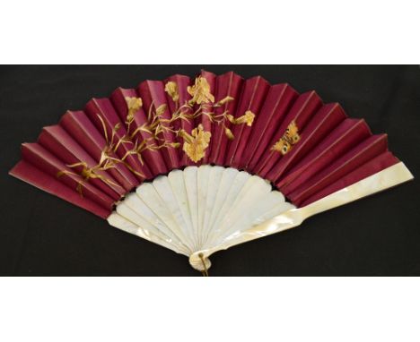 An Edwardian folding fan with mother of pearl plain guards and sticks, with a loop and ring, the mount of maroon satin hand e