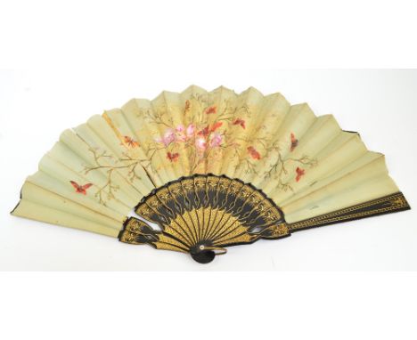 A late Victorian/Edwardian folding fan with gilt heightened ebonised guards and sticks with mother of pearl edged rivet suspe