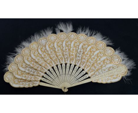 An early 20th century palmette folding fan with carved and pierced bone guards with circular motifs and matching sticks, star