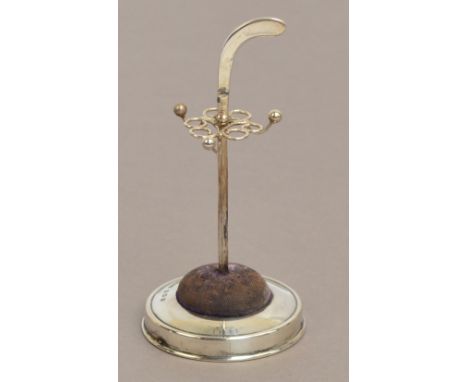 An Edward VII hallmarked silver hat pin stand in the form of a golf club, with scrolled wire pin supports and three ring hook